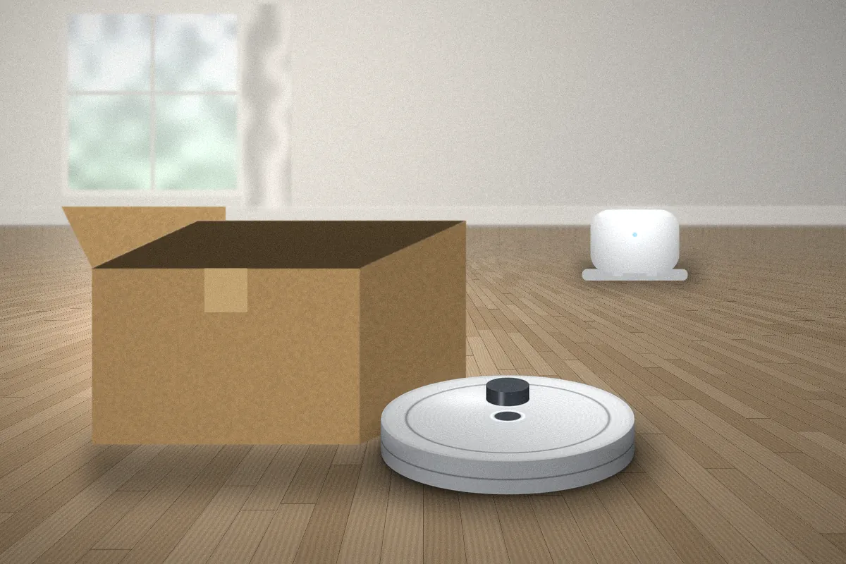 Open cardboard box next to a white robot vacuum and its charging dock